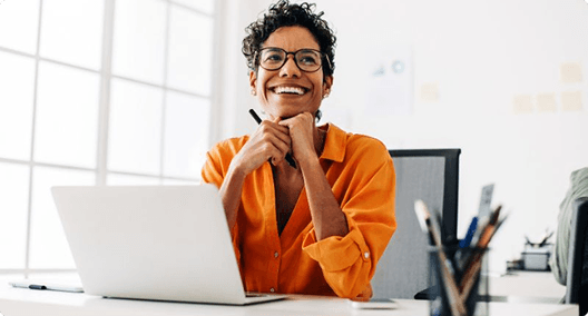 Woman working on laptop smiling